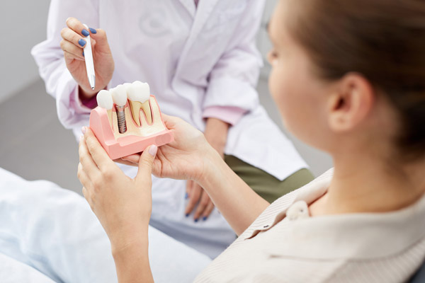 A patent holding a model of dental implants A patent holding a model of dental implants