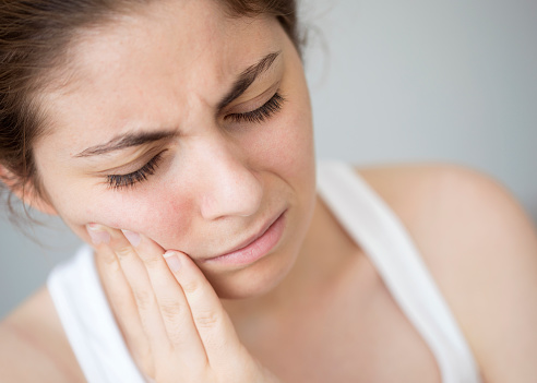 A woman with sore mouth from grinding her teeth