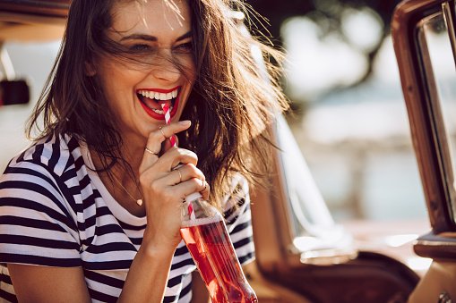 Woman smiling with fizzy drink before appointment at Parkside Dental in Murphy, TX
