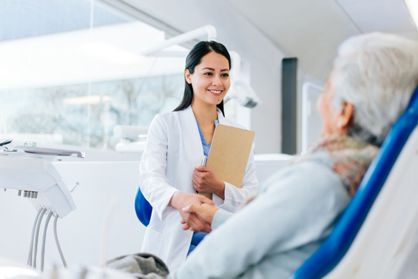 Dentist shaking patient's hand