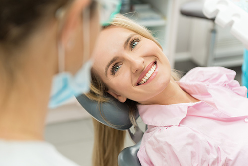A woman Learning more about the dental implant process